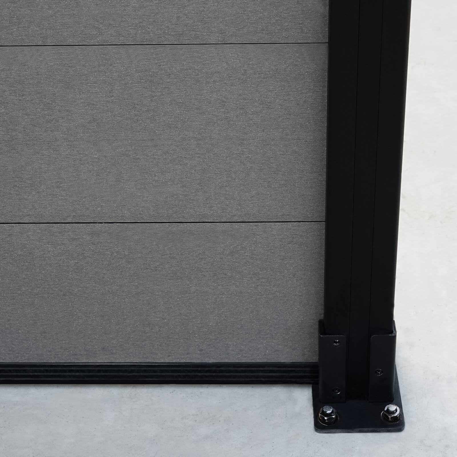 Silver gray composite fence with sleek co-extrusion design, attached to black metal post, ideal for NJ homes on concrete