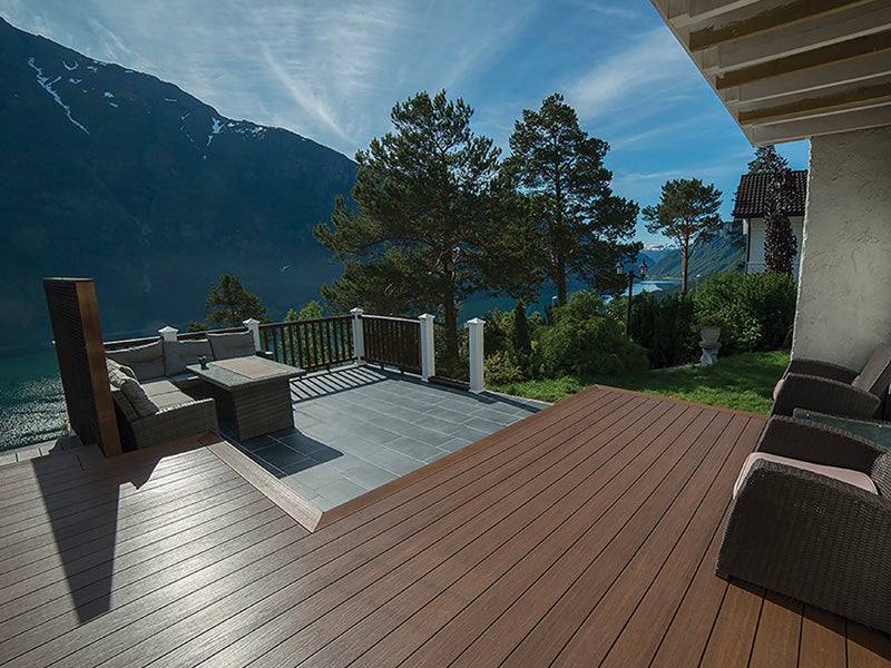 Dark brown teak composite decking with natural grain, perfect for NJ outdoor spaces with lake and mountain views.