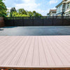 Light brown walnut composite deck planks with smooth surface, dark brown fence, blue sky, ideal for NJ outdoor spaces.