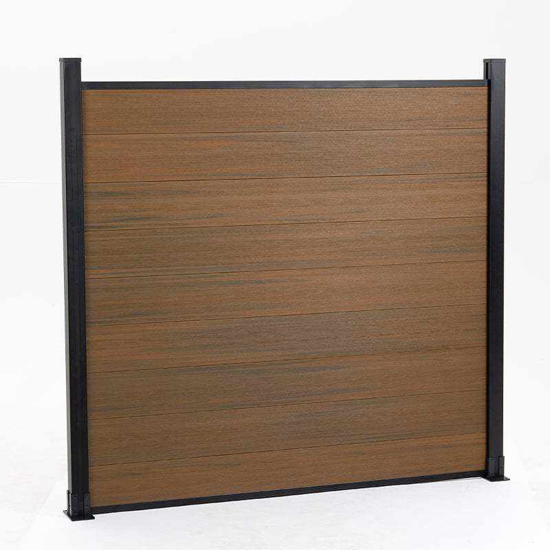 Brown composite fence with walnut wood grain texture, supported by black metal posts, available wholesale in NJ. 645