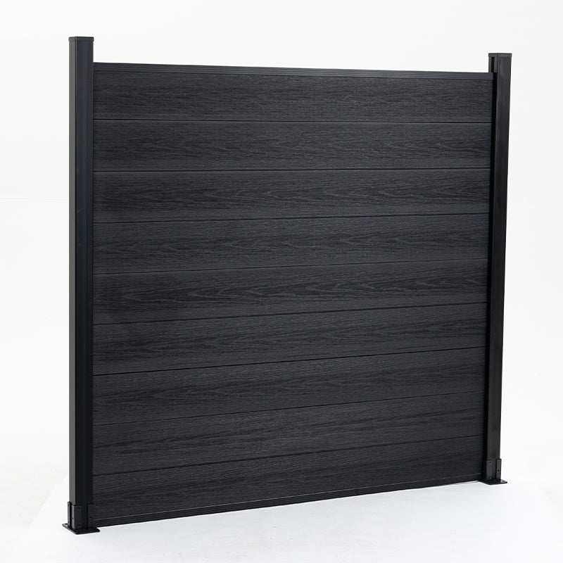 Black composite fence with horizontal planks, slight color variation, supported by sturdy posts. Durable co-extrusion