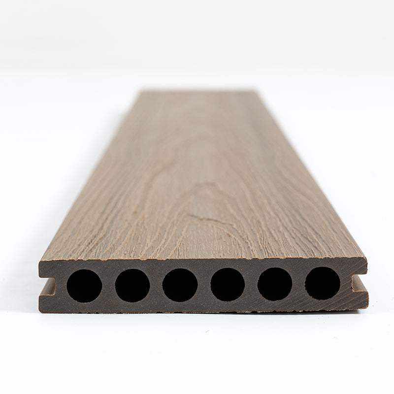 Light brown walnut composite deck board with wood grain texture, hollow core, and seven evenly spaced holes, available in New