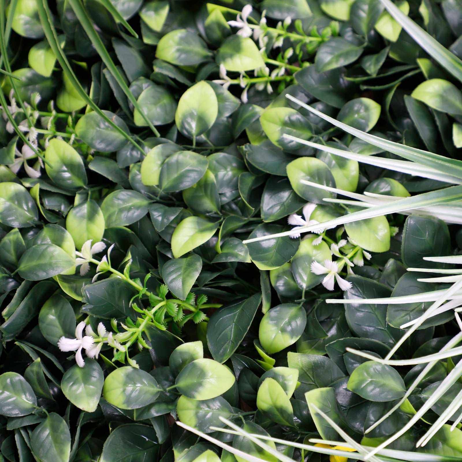 UV-resistant 40x40 artificial grass wall panel with realistic green leaves and white flowers, perfect for NJ indoor &