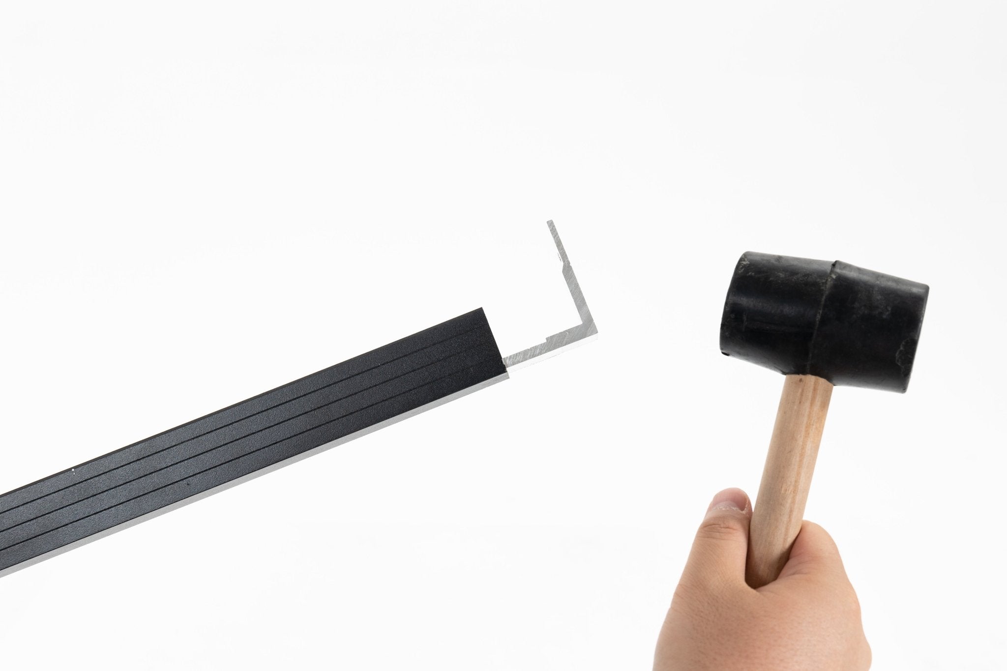 Black rubber mallet with wooden handle used for installing durable composite fences in New Jersey, showcasing quality