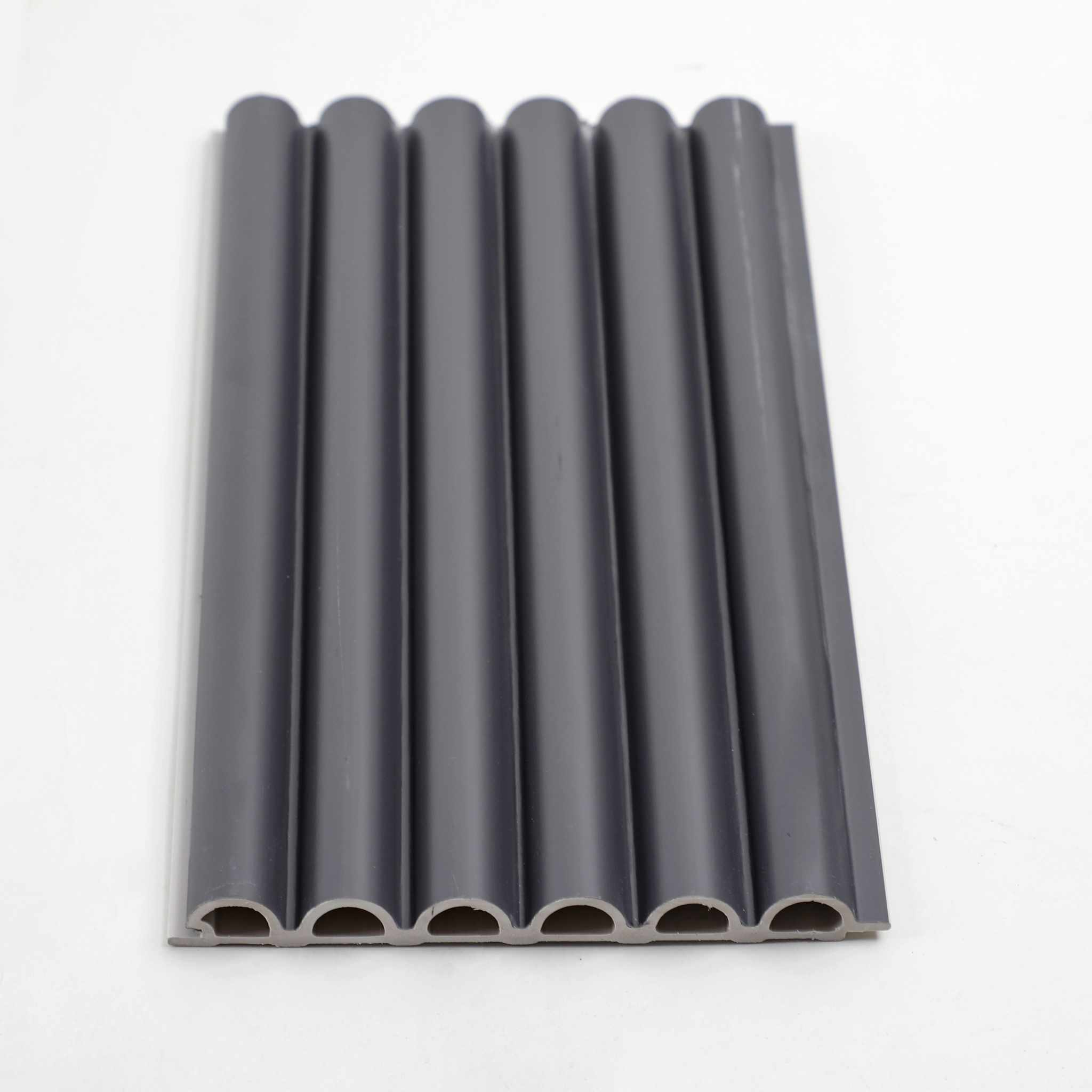 Black WPC corrugated sheeting with glossy round holes, durable and flexible, ideal for roofing or fencing in NJ.