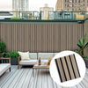 Modern medium-brown wood-like composite wall cladding panels with black gaps, ideal for NJ outdoor privacy fences and