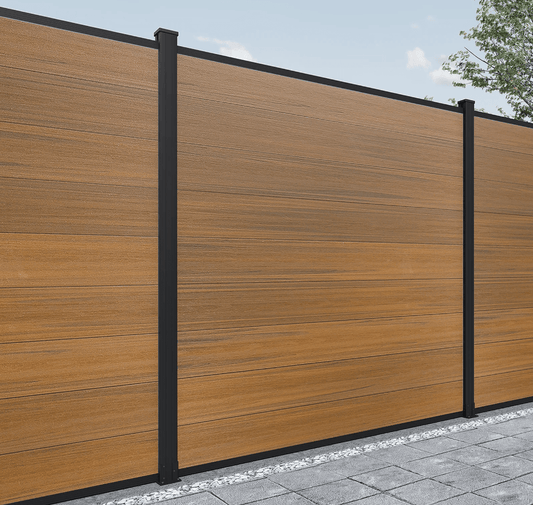 Brown composite fence with wood grain texture, horizontal planks, installed on stone foundation in NJ.