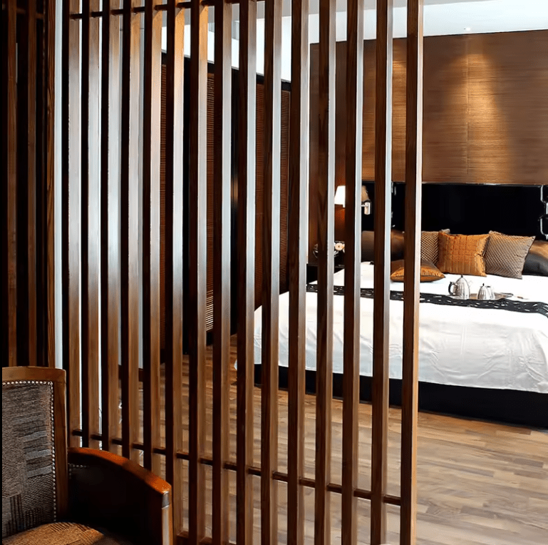 Dark brown WPC timber tubes, 4x2 inches, 9.5 feet long, used in stylish wooden slatted bedroom partitions in NJ.