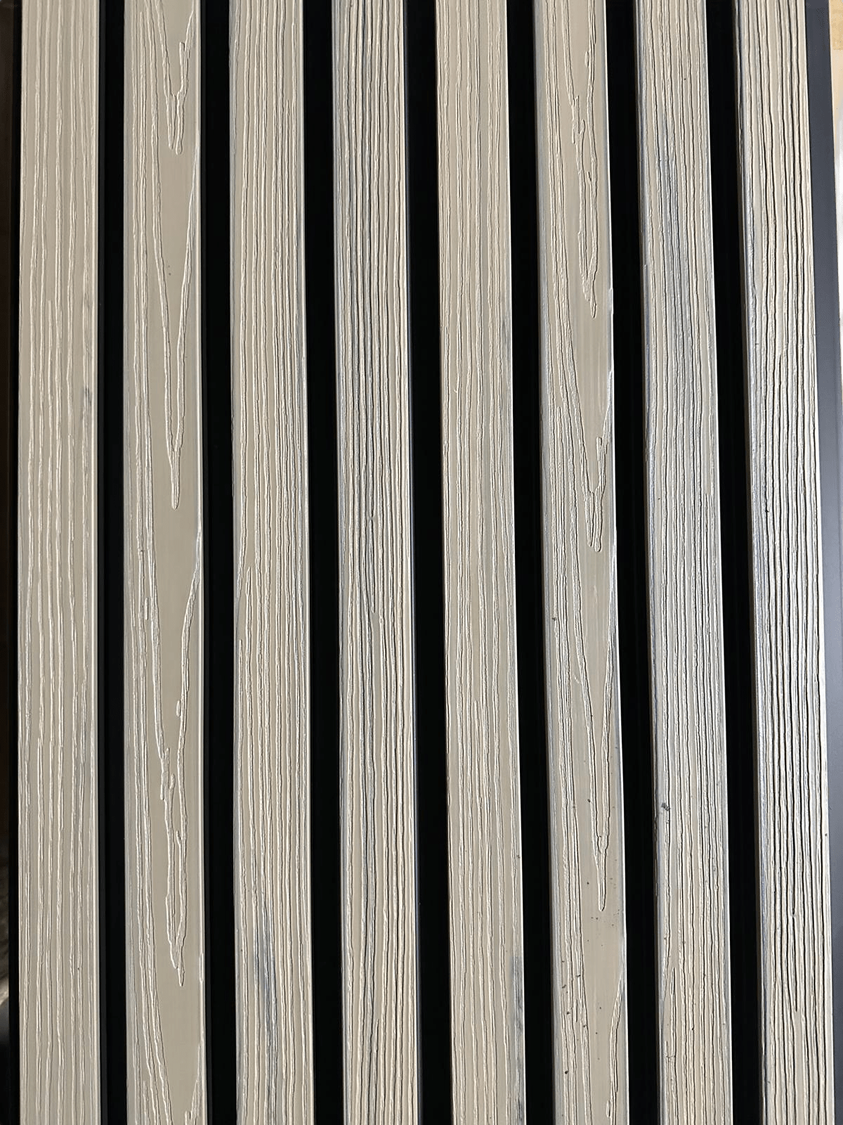 Light brown wood-grain composite wall cladding panels with vertical black lines, durable co-extruded design, perfect for NJ